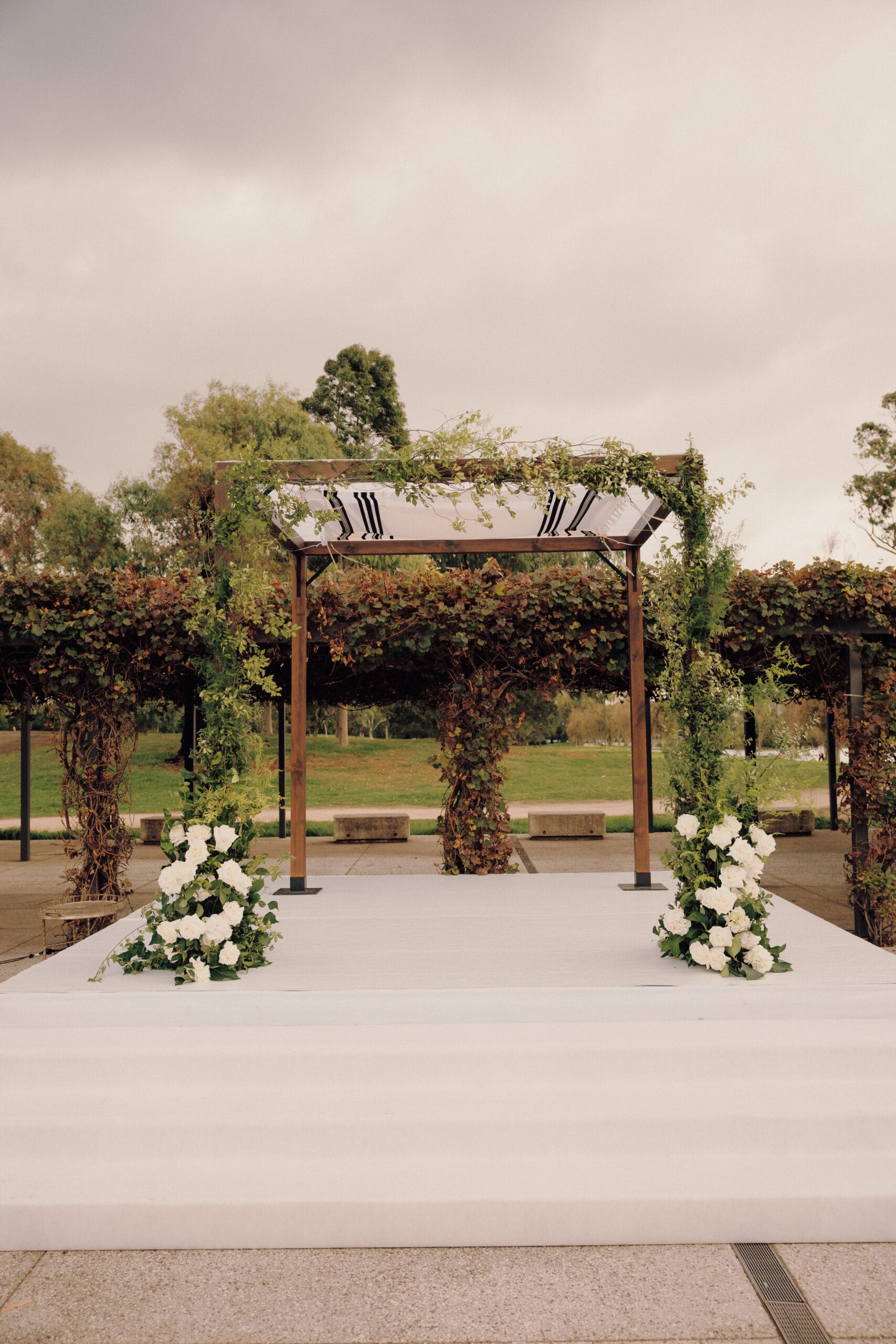 Dark Stain Timber Chuppah at Carousel with fresh florals