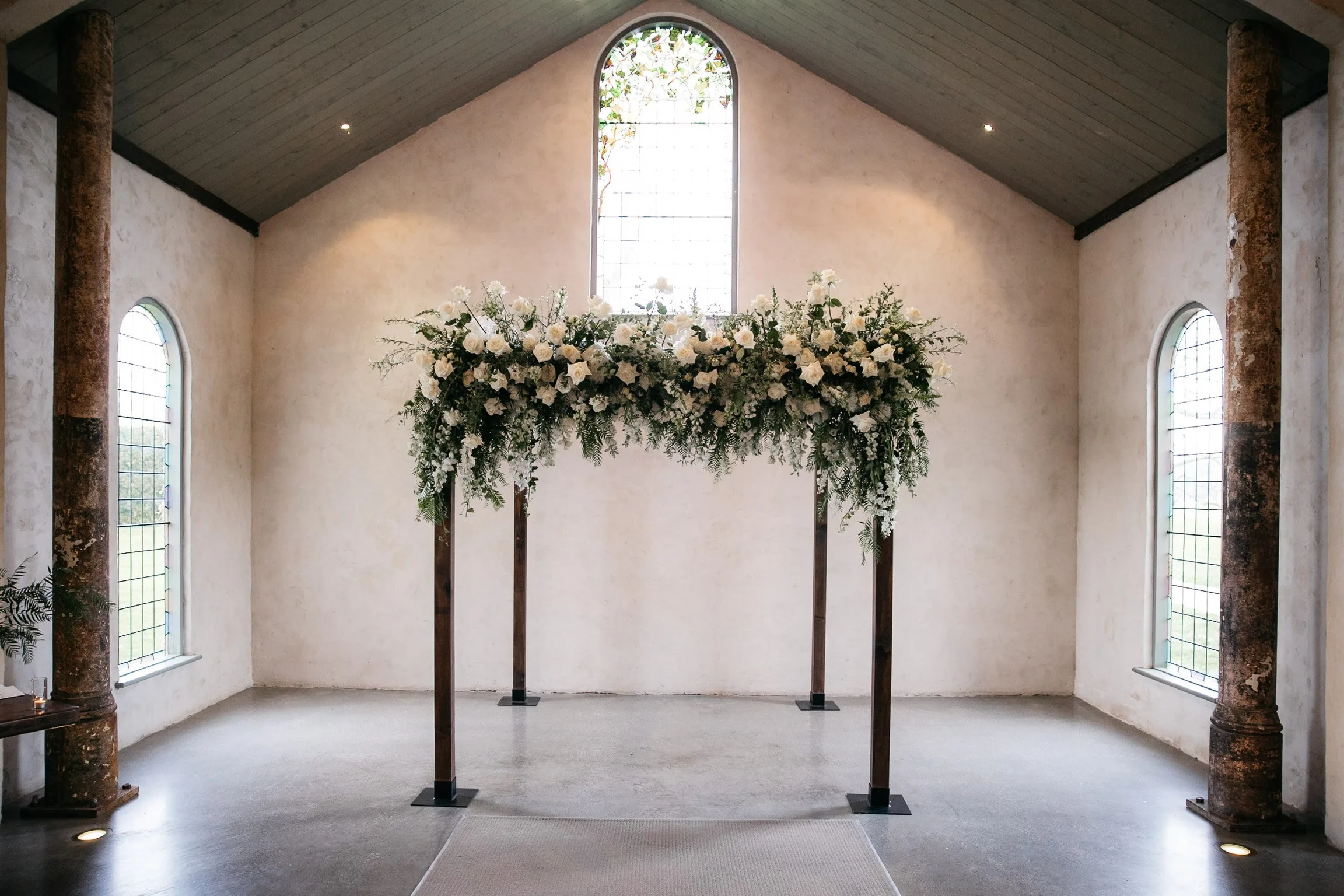 Dark stain timber Chuppah with fresh florals at Stones of the Yarra Valley
