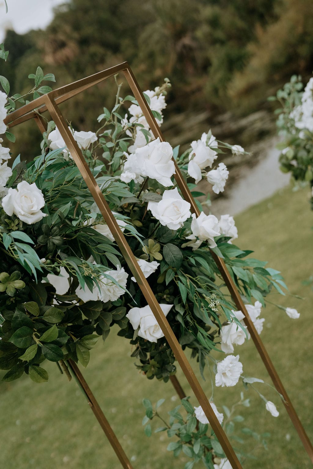 Gold stand (1.8mH x 30cmW x 30cm) including silk white floral and foliage arrangement