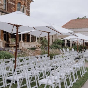 White Wooden Chairs and umbrellas at Rippon Lea Estate