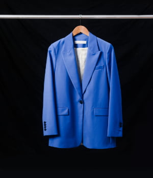 Blue,Suit,Jacket,On,Hanger,Isolated,On,Black,Background.