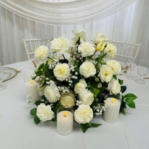 Low silk floral centrepiece (whites and greens) with 3 LED pillar candles