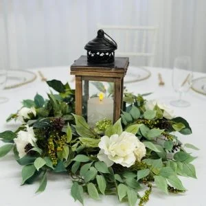 Rustic brown lantern with LED candle on tree trunk base and silk floral wreath