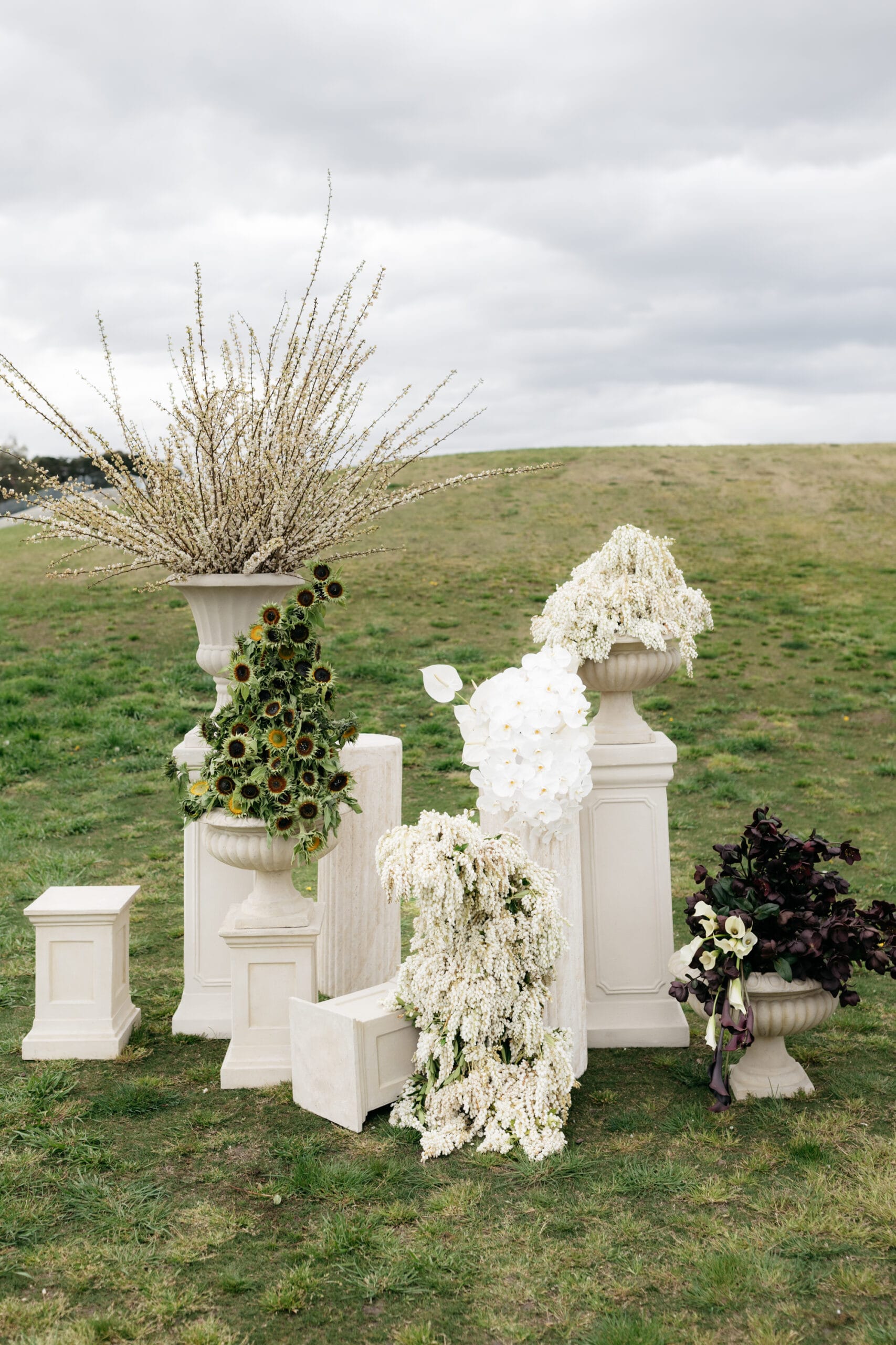 Assorted Sandstone Urns and Pedestals with Marble Ripple Plinths at Huberts Estate
