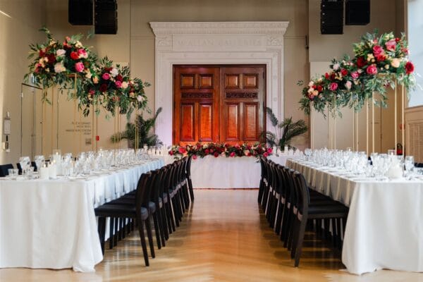 Gold stand with pink, red and beige silk floral arrangement with foliage - Image 3